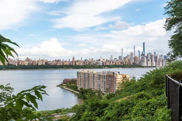 a view of a lake with houses in front of it