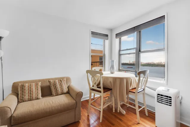a living room with furniture and a floor to ceiling window