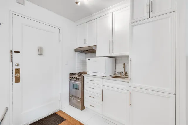 a kitchen with cabinets and a stove