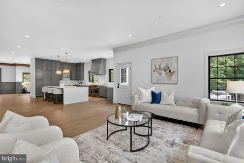 a living room with furniture and a painting on the wall
