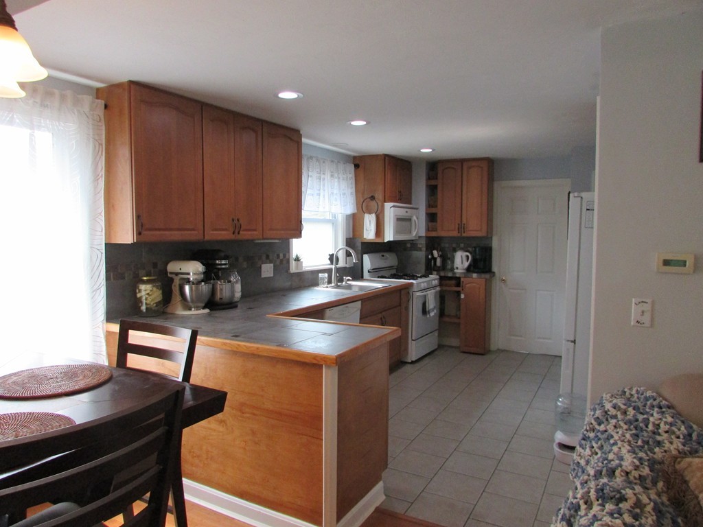 28 Alder Road Norton, MA 02766 - Photo 6 of 27 a kitchen with kitchen island granite countertop a sink counter top space and cabinets