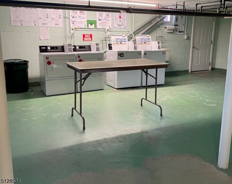 153 Ridge Road, Unit D Cedar Grove, NJ 07009 - Photo 18 of 21 a room with table chairs and stainless steel appliances