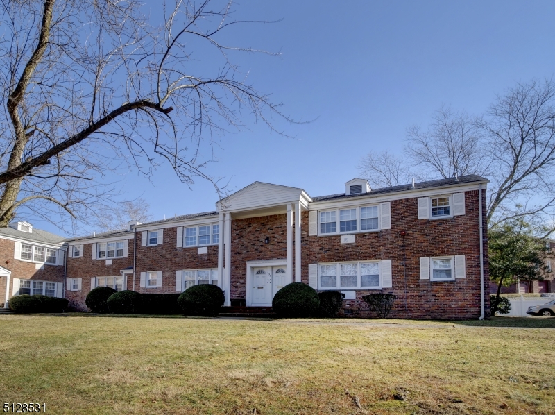 153 Ridge Road, Unit D Cedar Grove, NJ 07009 - Photo 2 of 21 a front view of a building with garden