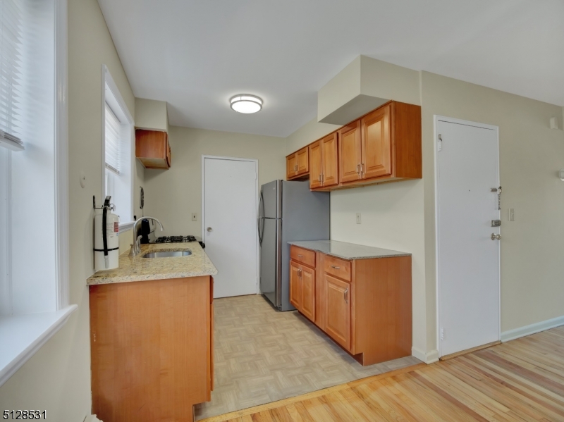 153 Ridge Road, Unit D Cedar Grove, NJ 07009 - Photo 10 of 21 a kitchen with stainless steel appliances granite countertop a stove a refrigerator and a sink