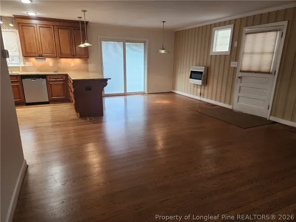 a kitchen with granite countertop wooden cabinets and granite counter tops