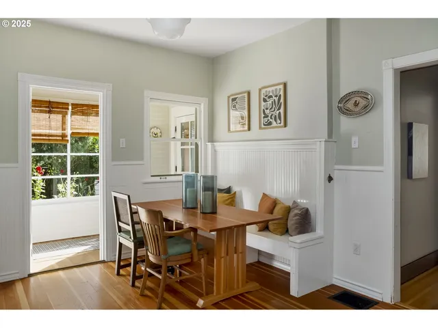 a view of a dining room with furniture and a window