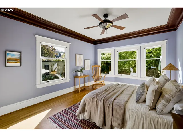 a bedroom with a bed and a large window