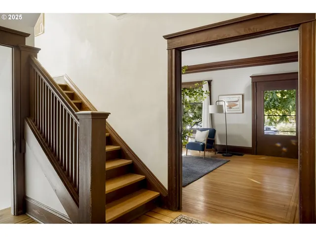 a view of a hallway view with wooden floor and staircase
