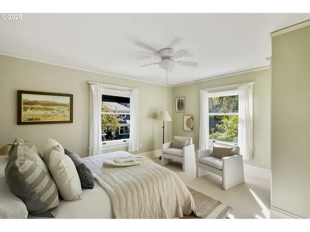 a bedroom with a large bed couch and a window