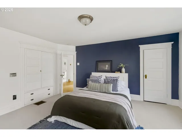 a bedroom with a bed and a painting