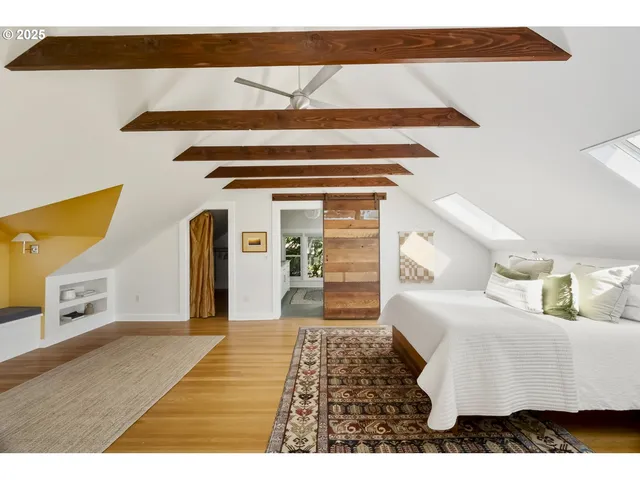 a bedroom with a bed and a mirror on the dresser