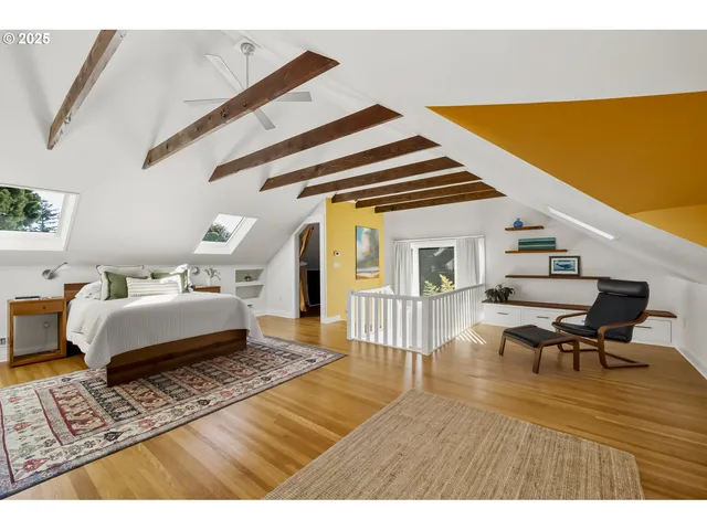 a bedroom with furniture and a wooden floor