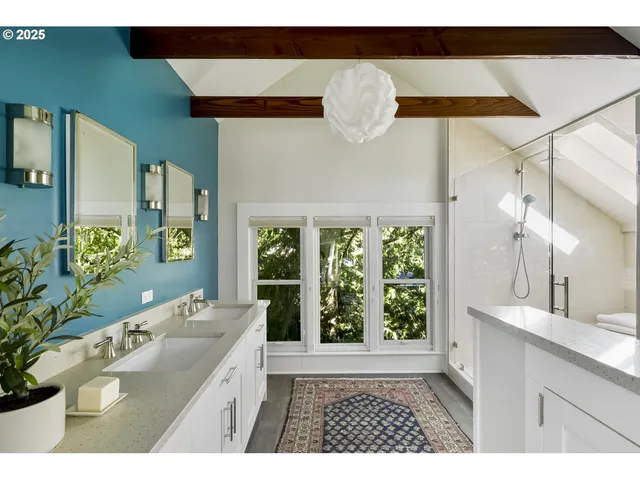 a bathroom with a sink a large mirror and a bathtub