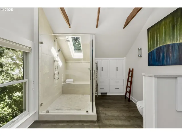a view of a bathroom with a glass door shower and a sink
