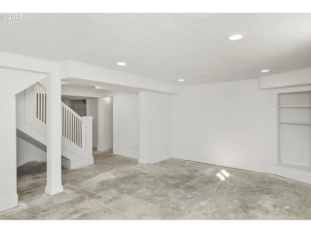 a view of an empty room with stairs