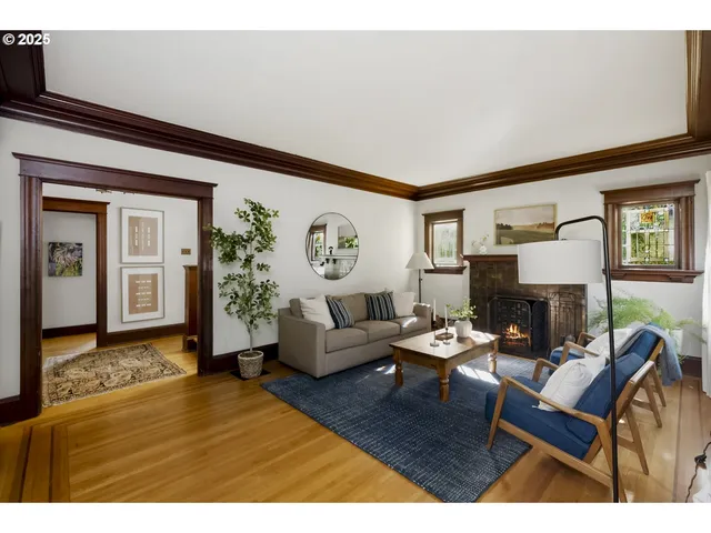 a living room with fireplace furniture and a wooden floor