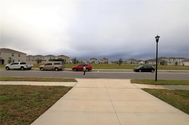 a view of swimming pool with lawn chairs