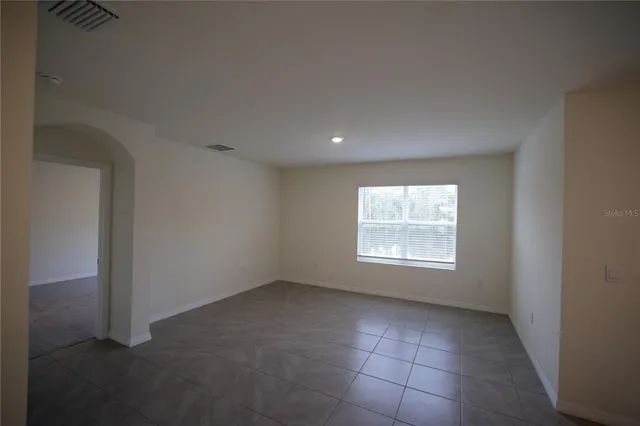 a kitchen with kitchen island a stove sink and cabinets