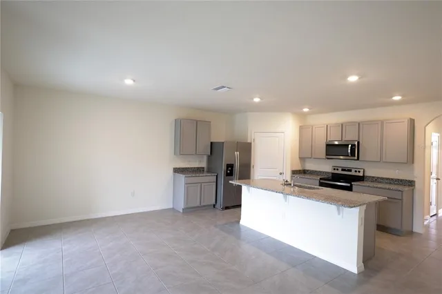 an empty room with a empty space and windows