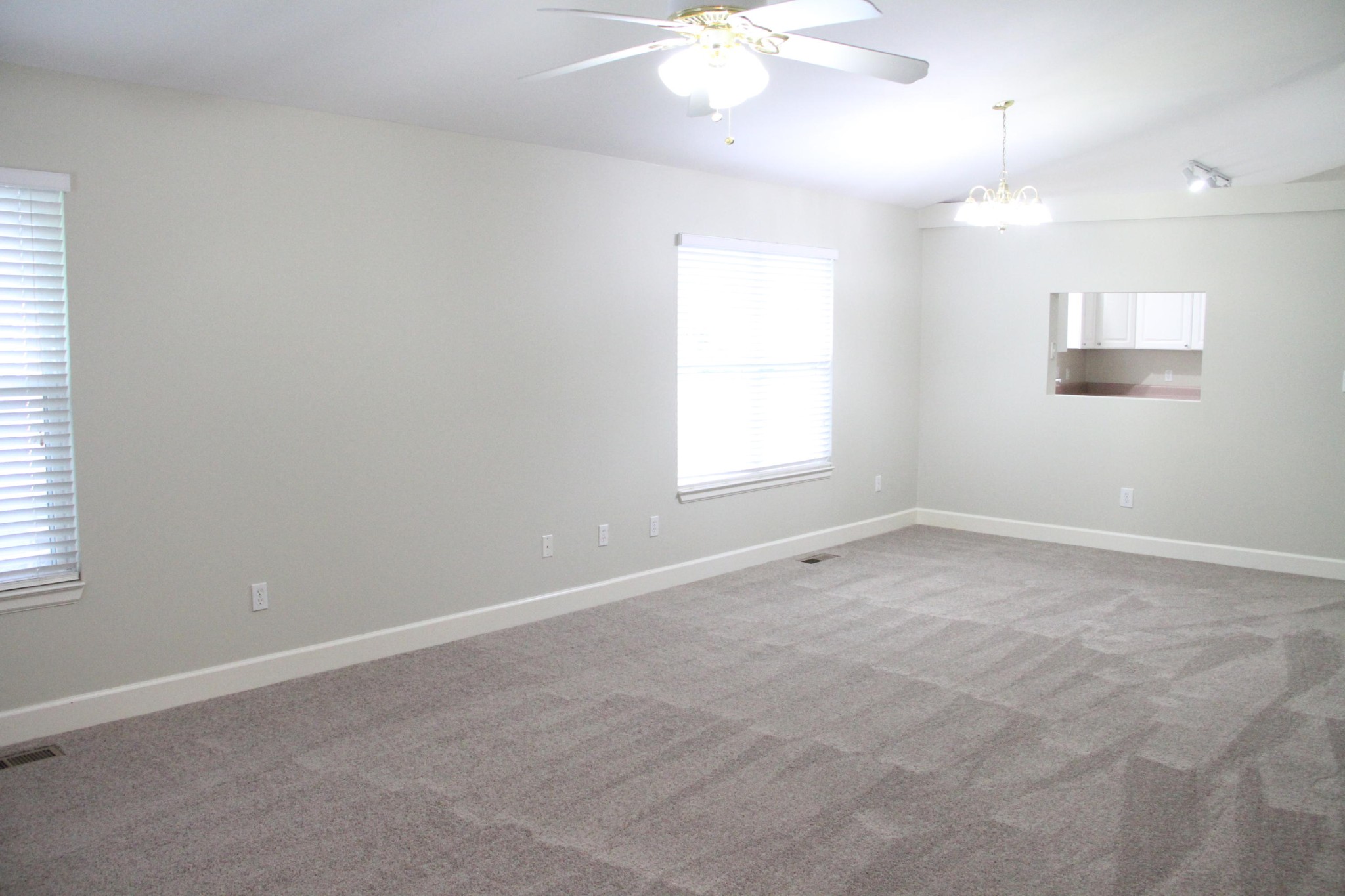 61612 Steekee Road Loudon, TN 37774 - Photo 10 of 23 an empty room with windows and chandelier fan