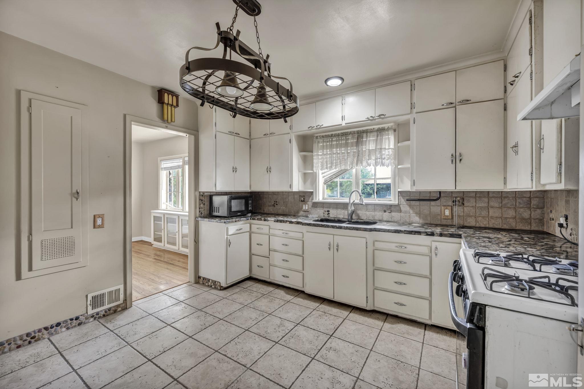 1035 Lander Street Reno, NV 89509 - Photo 11 of 40 a kitchen with a stove a sink and a refrigerator