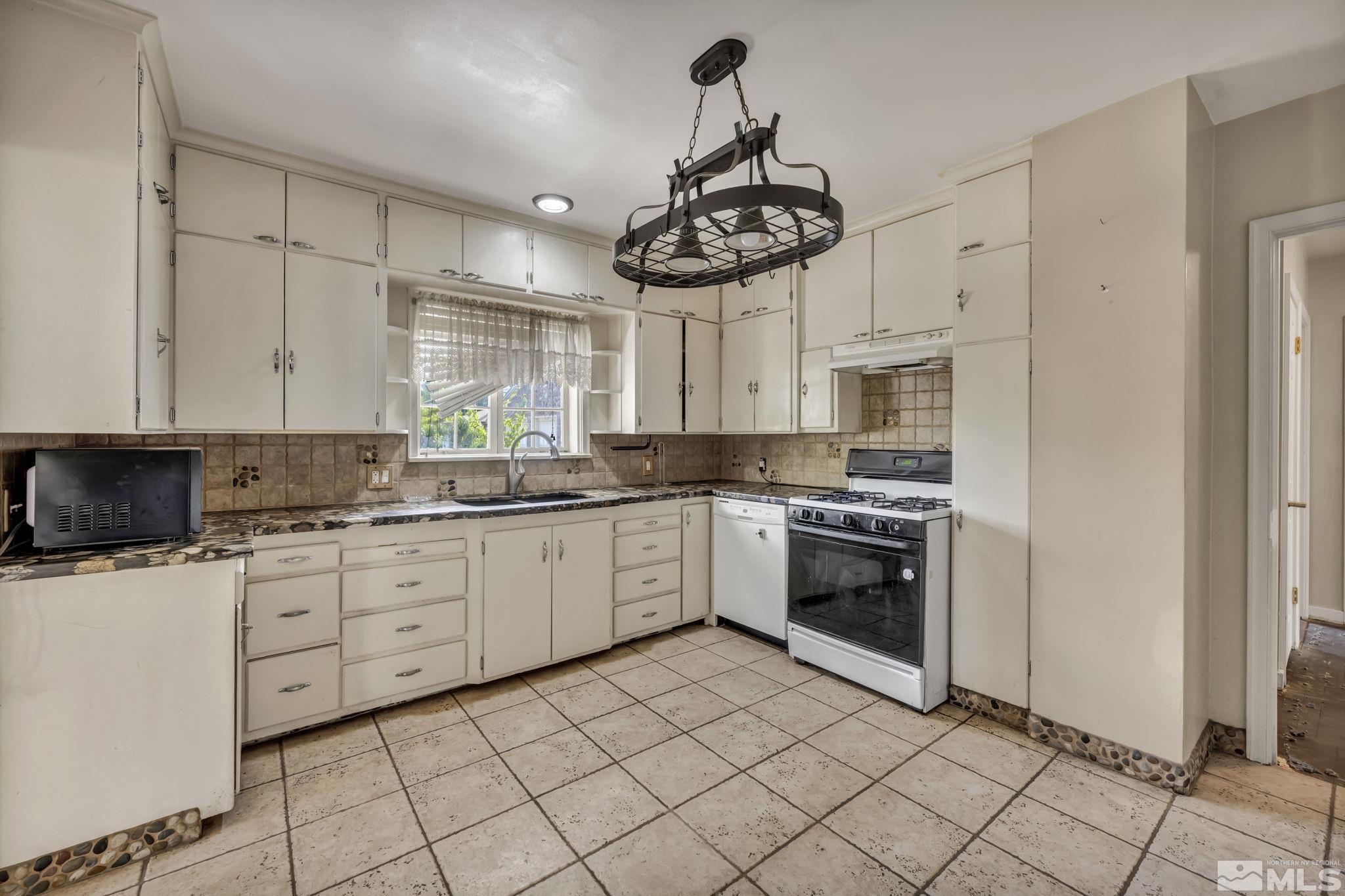 1035 Lander Street Reno, NV 89509 - Photo 10 of 40 a kitchen with a stove cabinets and window