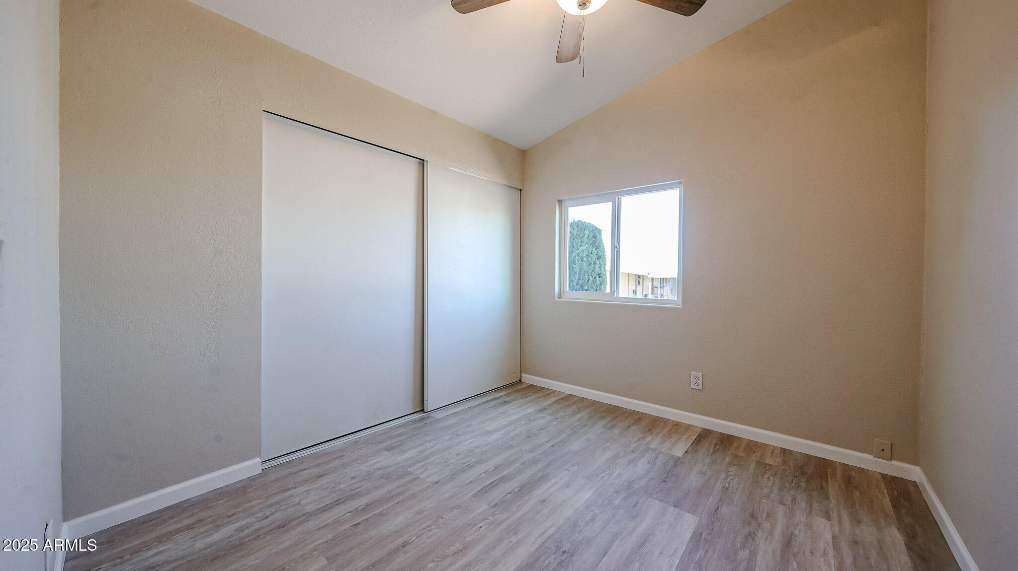 3901 East Pinnacle Peak Road, Unit 108 Phoenix, AZ 85050 - Photo 15 of 30 an empty room with a hardwood and ceiling fan