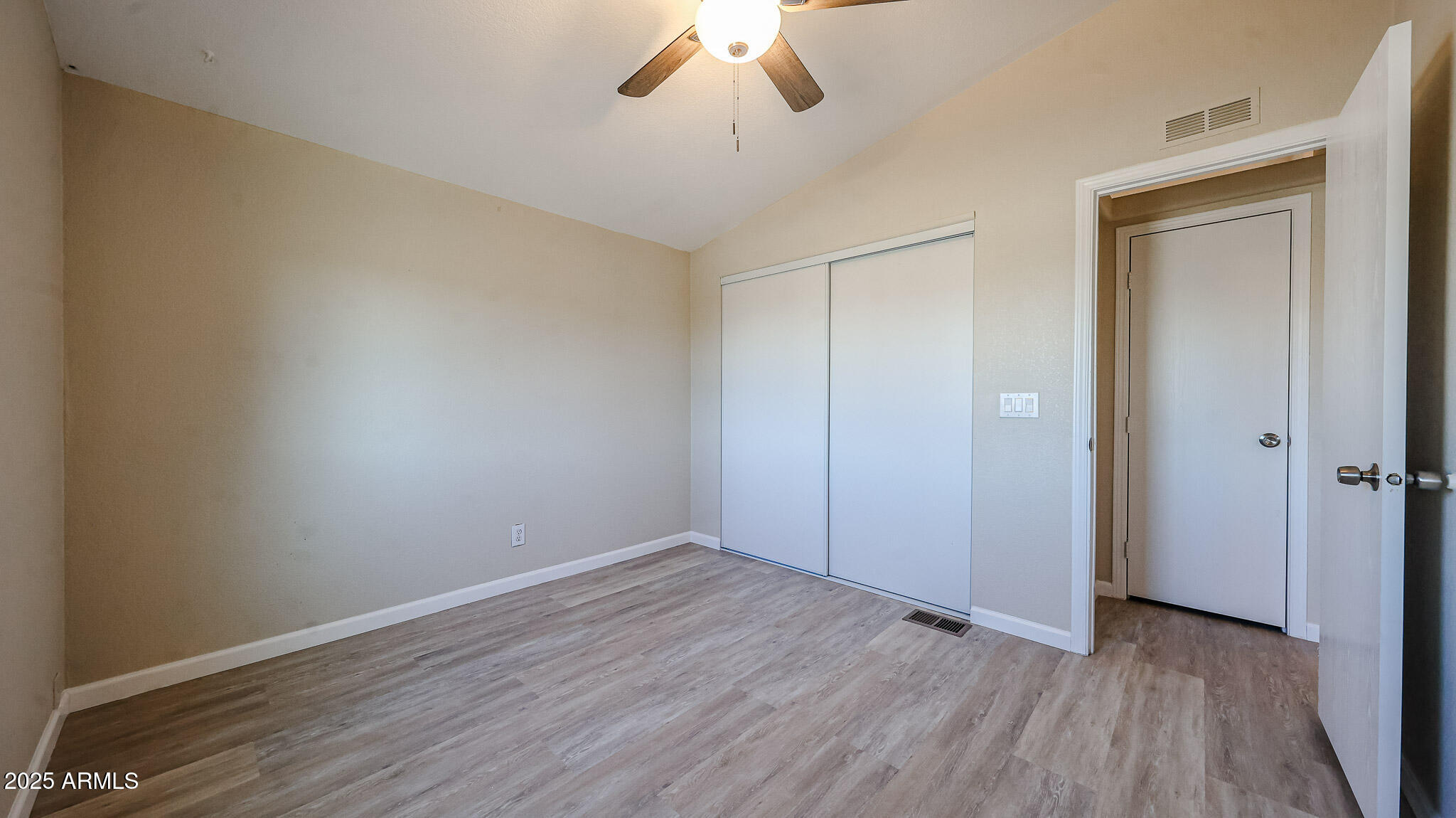 3901 East Pinnacle Peak Road, Unit 108 Phoenix, AZ 85050 - Photo 16 of 30 a view of an empty room with wooden floor