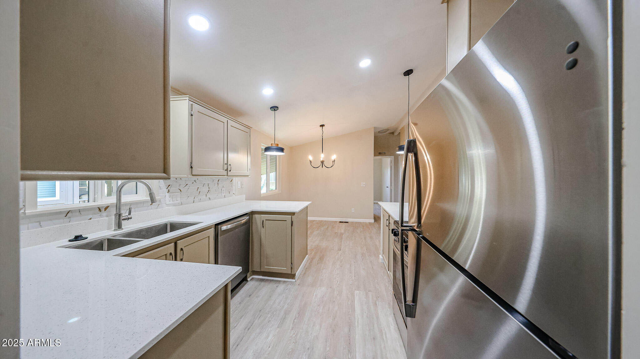 3901 East Pinnacle Peak Road, Unit 108 Phoenix, AZ 85050 - Photo 29 of 30 a kitchen with a sink a refrigerator and cabinets