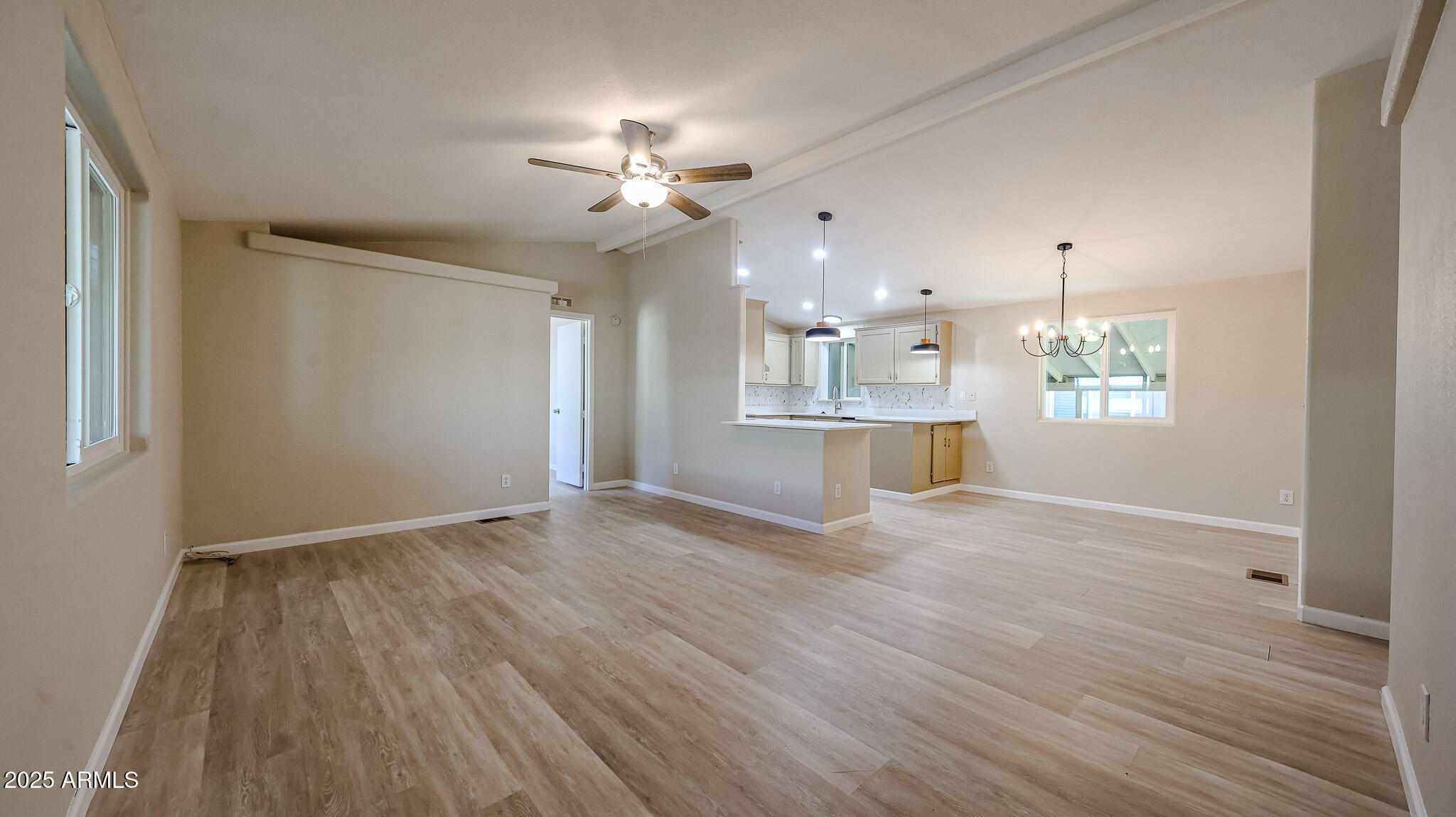 3901 East Pinnacle Peak Road, Unit 108 Phoenix, AZ 85050 - Photo 3 of 30 a view of an empty room with a window and wooden floor