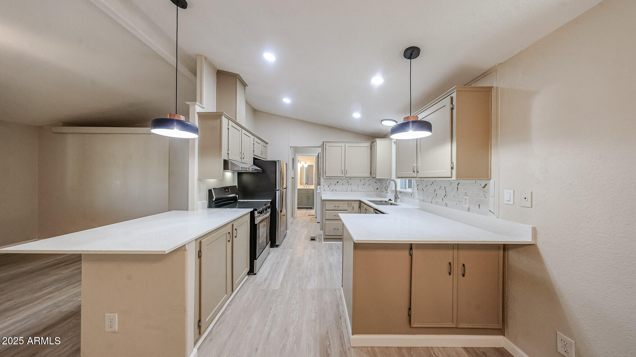 3901 East Pinnacle Peak Road, Unit 108 Phoenix, AZ 85050 - Photo 5 of 30 a kitchen with stainless steel appliances kitchen island granite countertop a sink stove and refrigerator