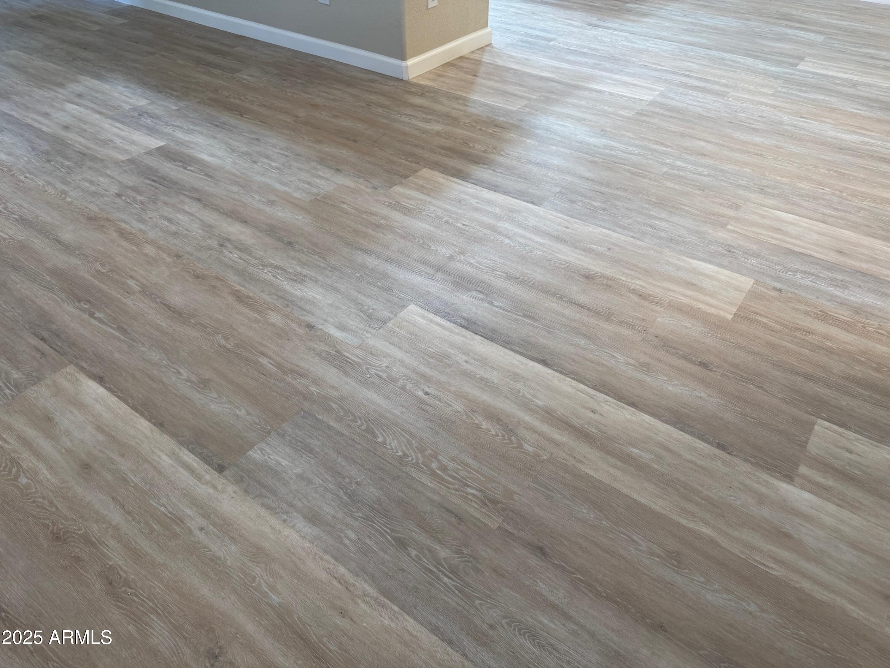 3901 East Pinnacle Peak Road, Unit 108 Phoenix, AZ 85050 - Photo 8 of 30 an empty room with wooden floor