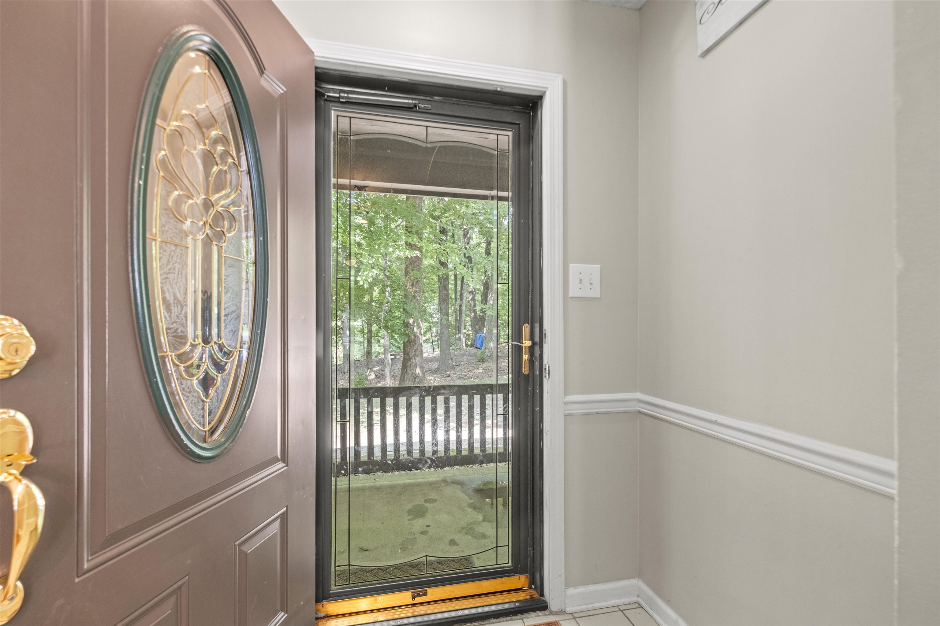 3601 Marshall Road Munford, TN 38058 - Photo 14 of 35 Entryway featuring a decorative oval glass insert door, a full-lite storm door, and tile flooring
