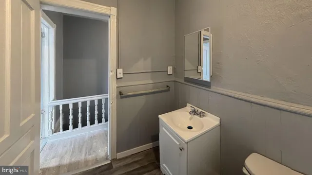 a bathroom with a toilet sink and mirror