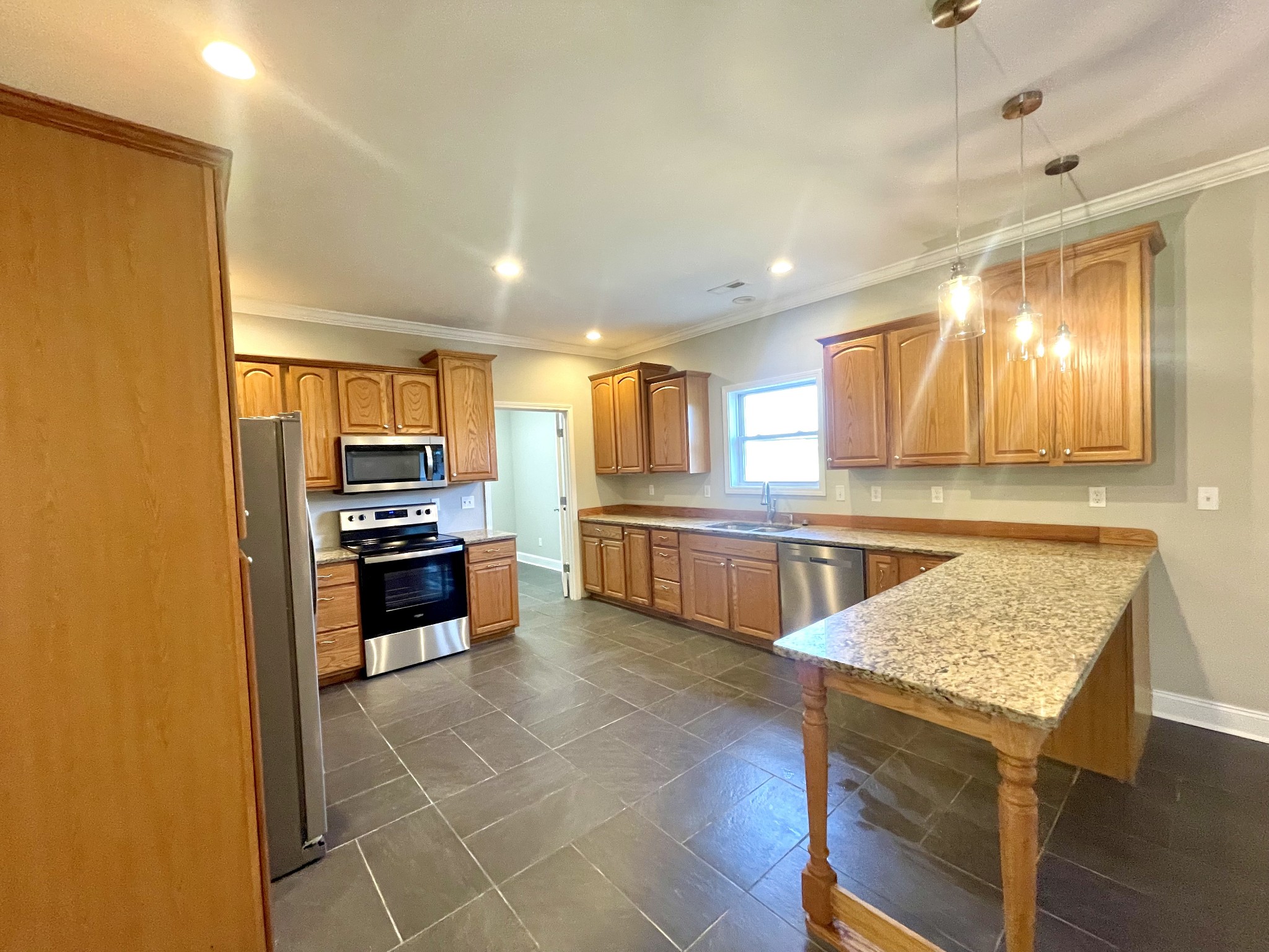 10591 Bell Station Road Oak Grove, KY 42262 - Photo 12 of 35 a kitchen with granite countertop a sink cabinets and stainless steel appliances