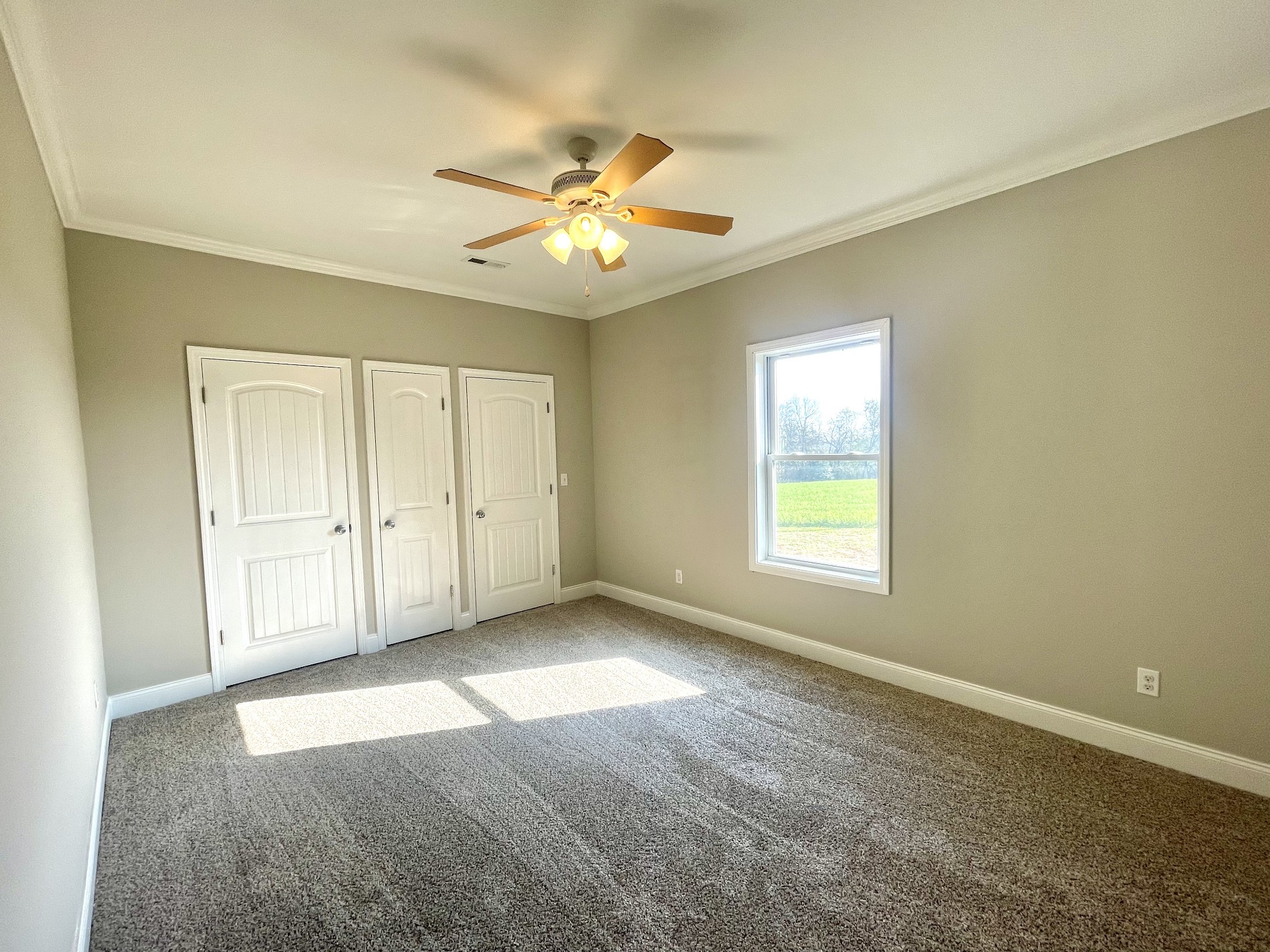 10591 Bell Station Road Oak Grove, KY 42262 - Photo 24 of 35 an empty room with windows and fan