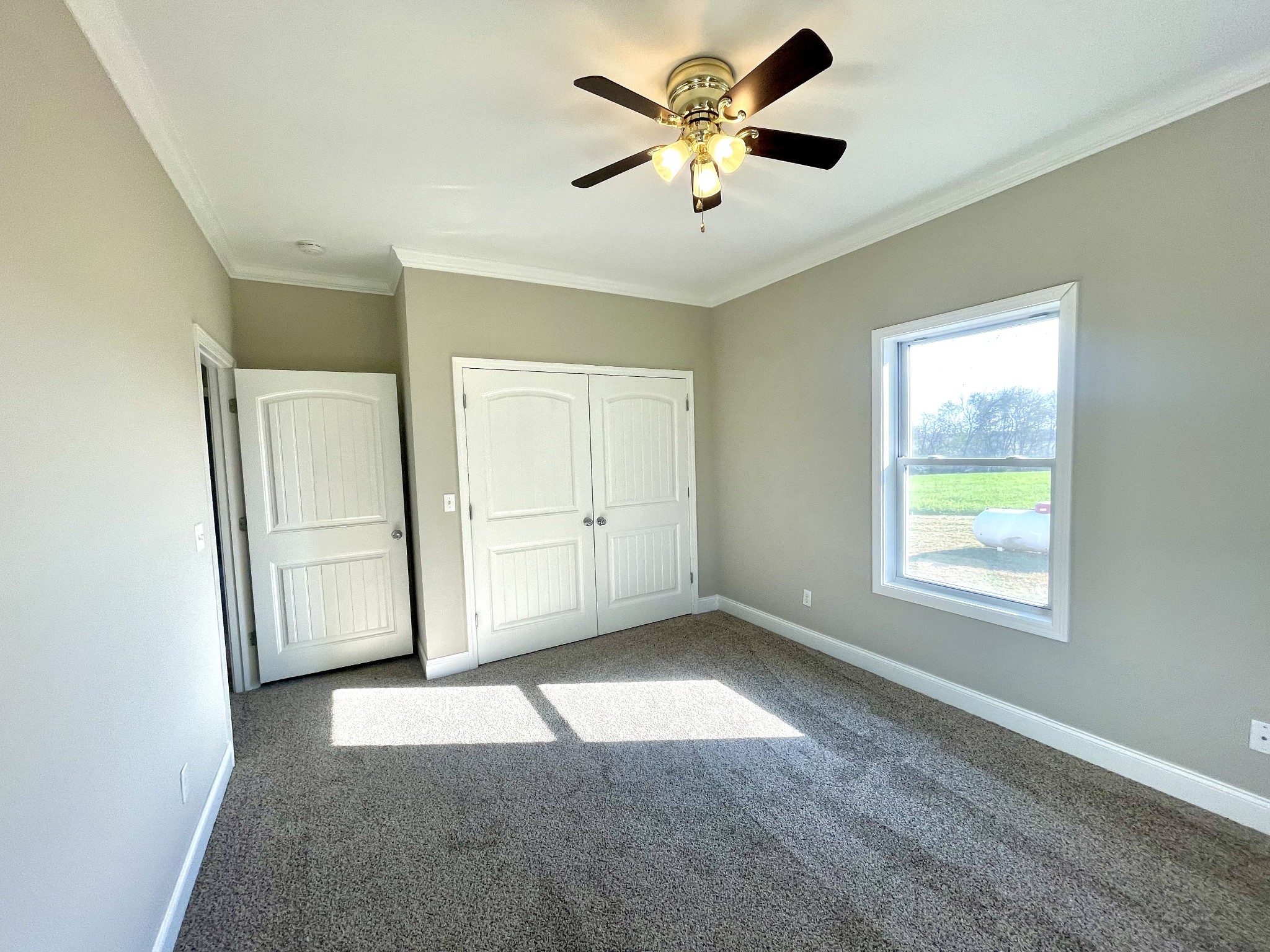 10591 Bell Station Road Oak Grove, KY 42262 - Photo 29 of 35 an empty room with a window and a fan
