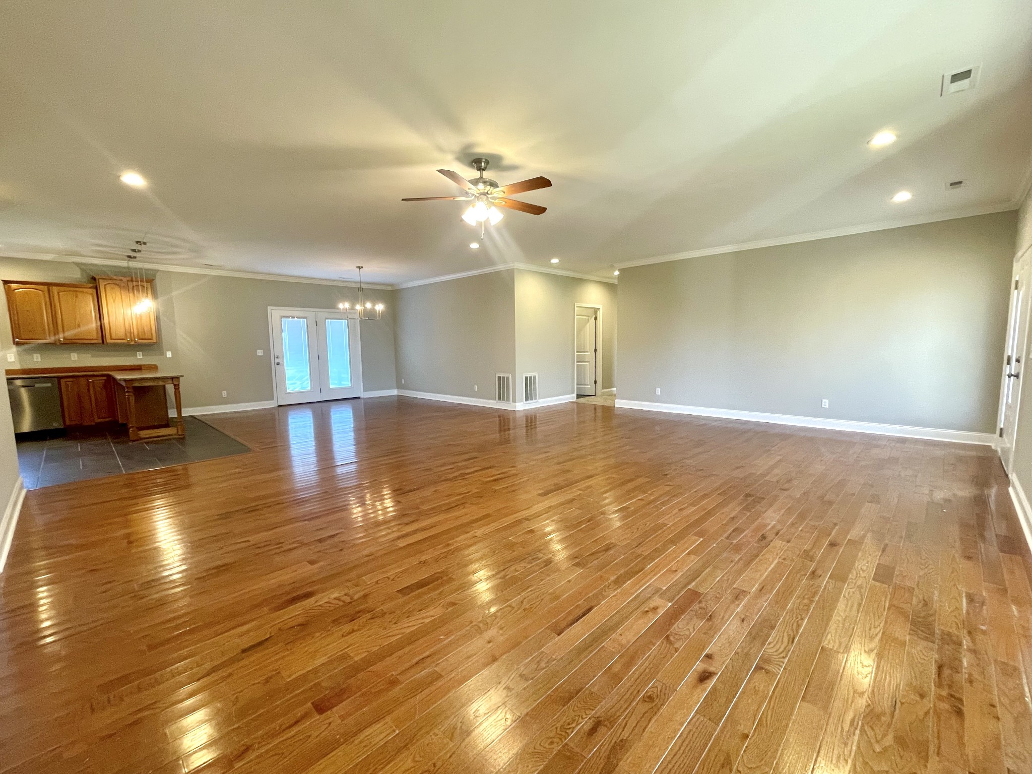 10591 Bell Station Road Oak Grove, KY 42262 - Photo 4 of 35 a view of an empty room and kitchen view with wooden floor