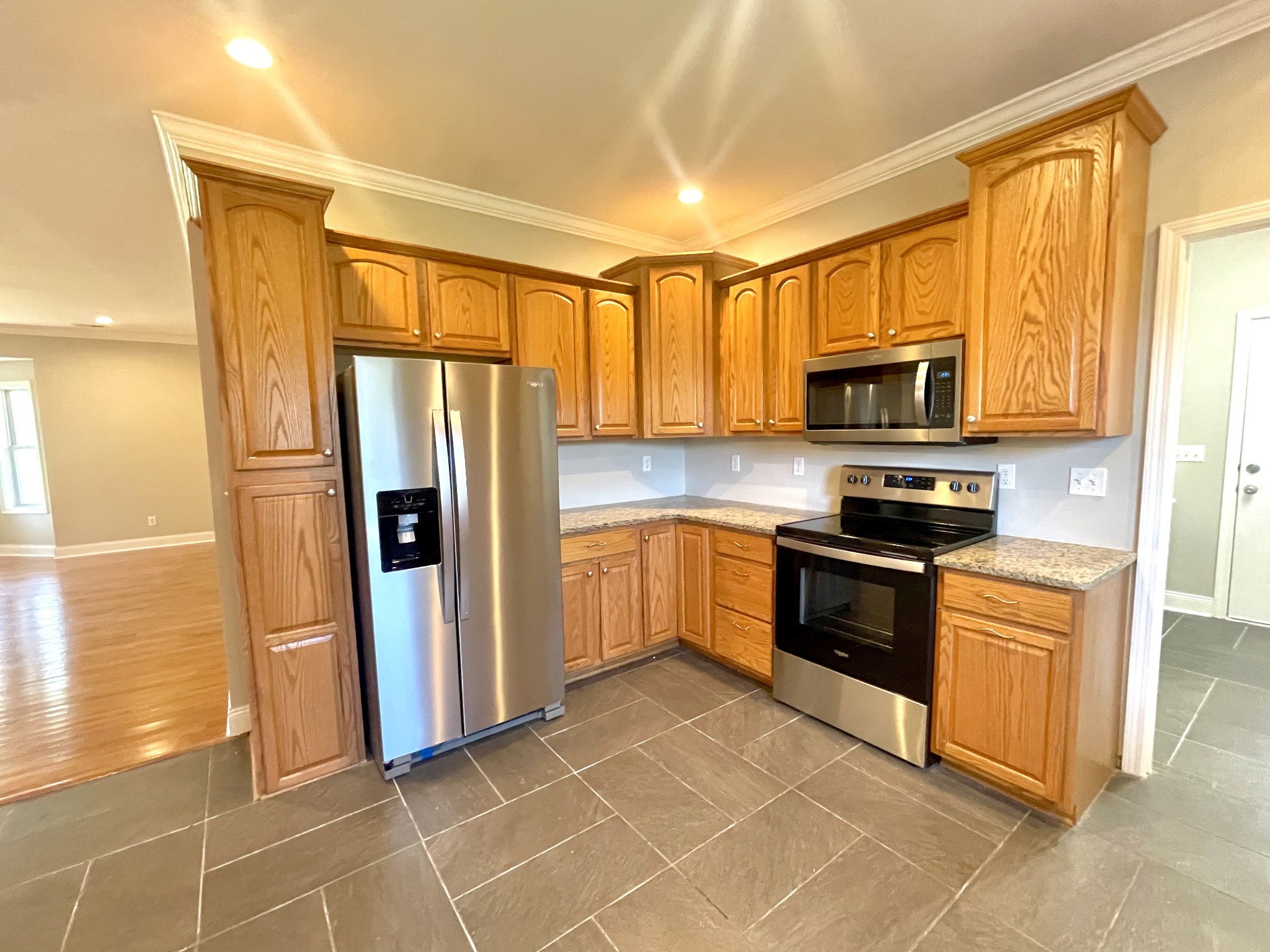 10591 Bell Station Road Oak Grove, KY 42262 - Photo 10 of 35 a kitchen with stainless steel appliances granite countertop a refrigerator stove and microwave