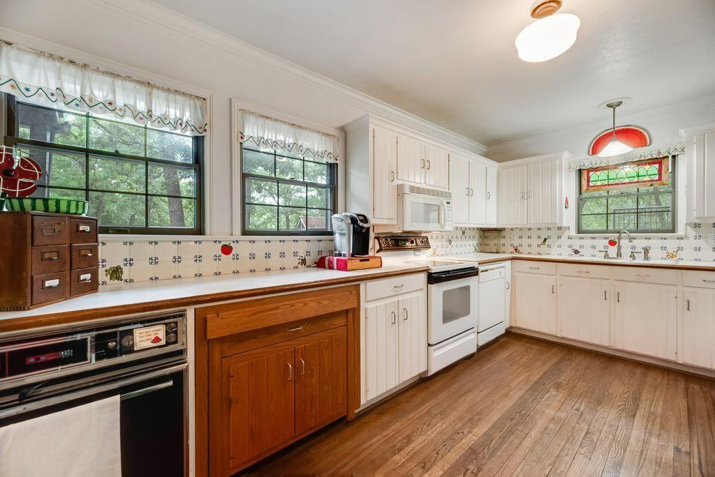 9875 Old Bridge Road Terrell, TX 75160 - Photo 18 of 40 a kitchen with a white stove top oven sink and window