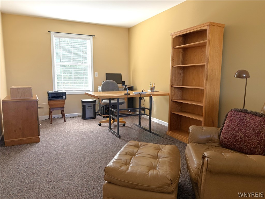 73 Chestnut Lancaster, NY 14086 - Photo 25 of 41 A quiet home office features wall-to-wall carpeting and a large window.