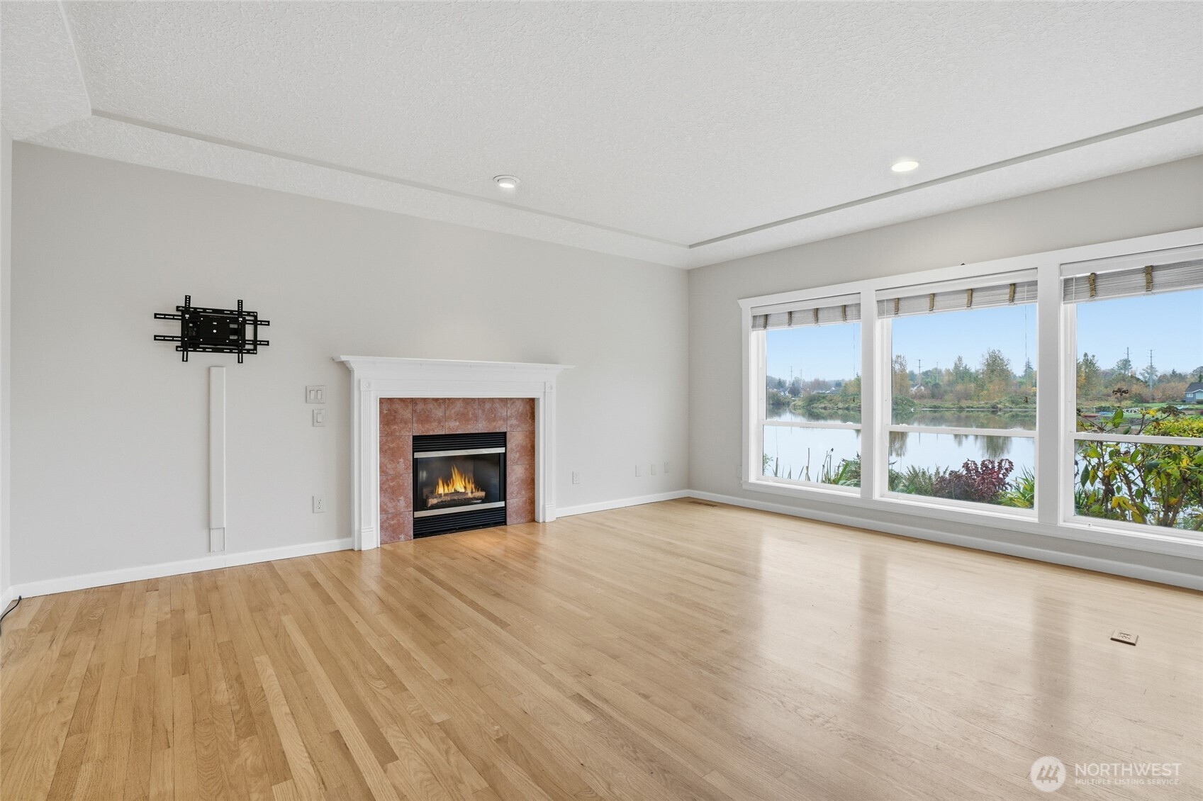 3550 Northeast 214th Avenue Fairview, OR 97024 - Photo 8 of 40 a view of an empty room with a window and fireplace
