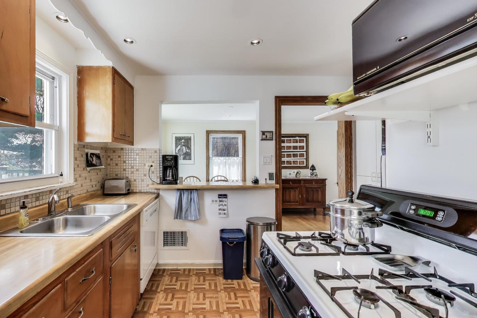 7837 East Prairie Road Skokie, IL 60076 - Photo 11 of 31 a kitchen with a sink stove top oven and refrigerator