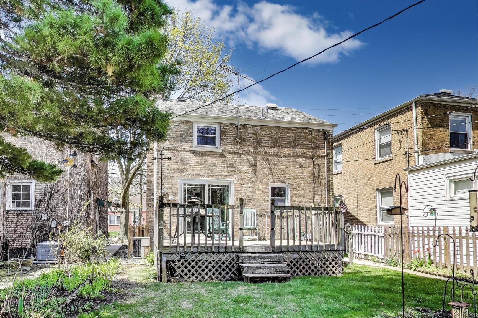7837 East Prairie Road Skokie, IL 60076 - Photo 23 of 31 a view of a house with a small yard and wooden fence
