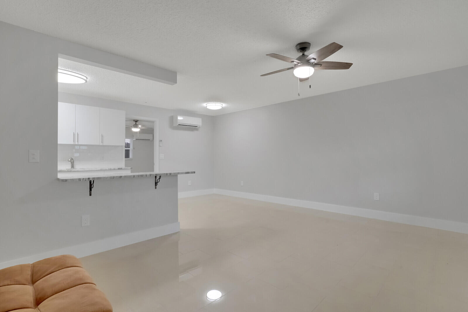 914 North Federal Highway, Unit 4 Lake Worth Beach, FL 33460 - Photo 2 of 18 a view of a livingroom with a ceiling fan and window