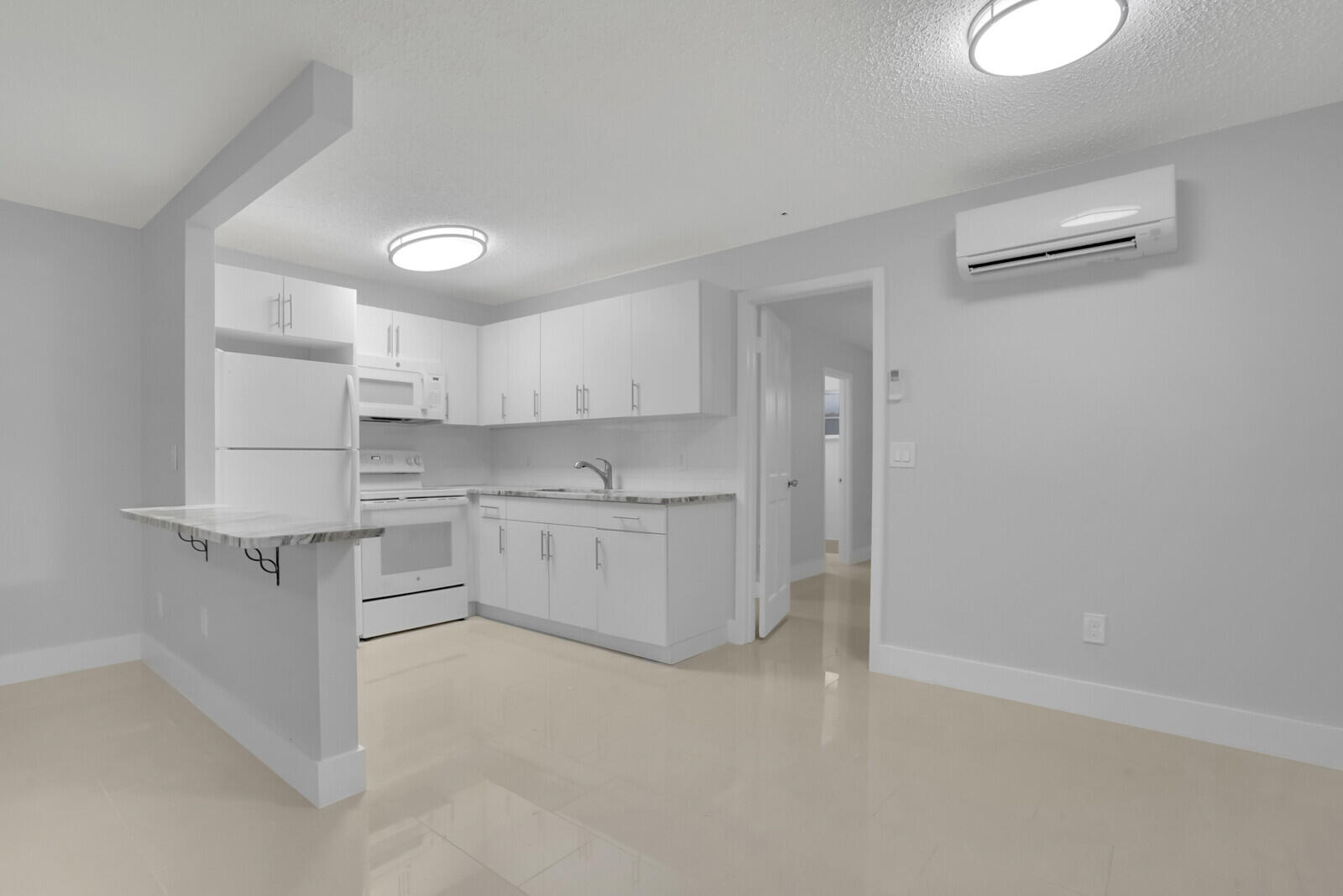 914 North Federal Highway, Unit 4 Lake Worth Beach, FL 33460 - Photo 4 of 18 a kitchen with white cabinets and white appliances