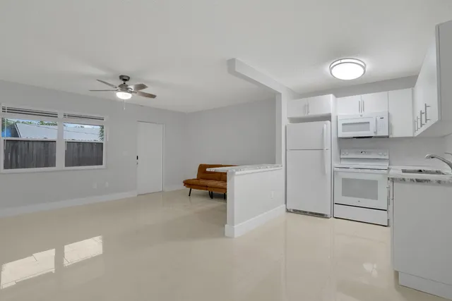 a view of kitchen with cabinets and appliances