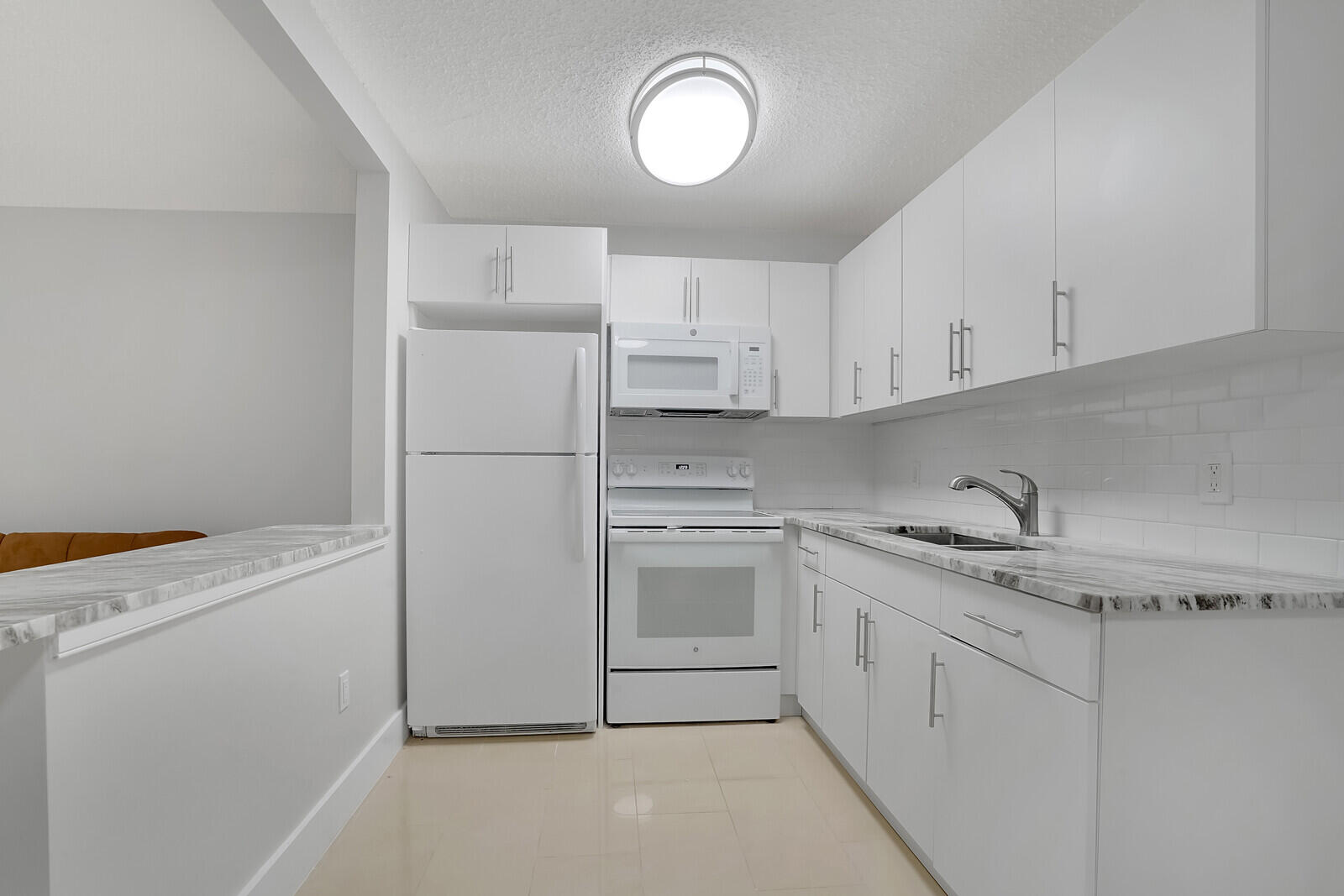 914 North Federal Highway, Unit 4 Lake Worth Beach, FL 33460 - Photo 6 of 18 a kitchen with white cabinets and white appliances