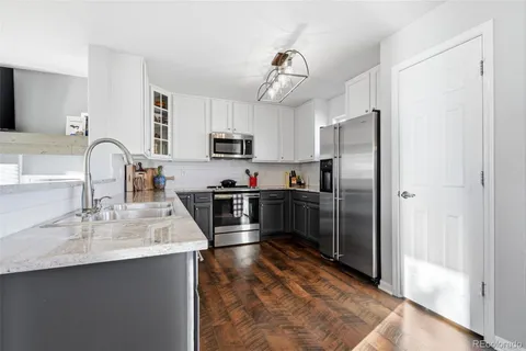 a kitchen with kitchen island a sink appliances and cabinets