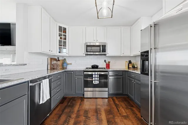 a kitchen with stainless steel appliances granite countertop a refrigerator sink and cabinets